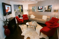 Waiting area with red chairs and TV