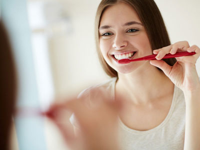 Steps to prevent tooth decay. Girl brushing teeth.