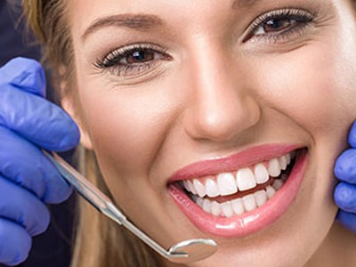 Smiling woman getting her teeth checked.