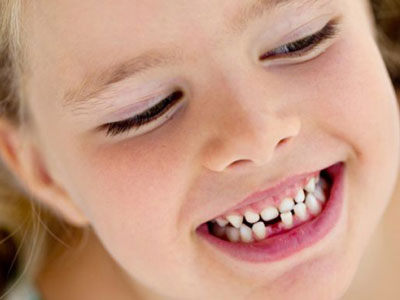 How do I know if my child needs orthodontic care? | Girl checking her teeth