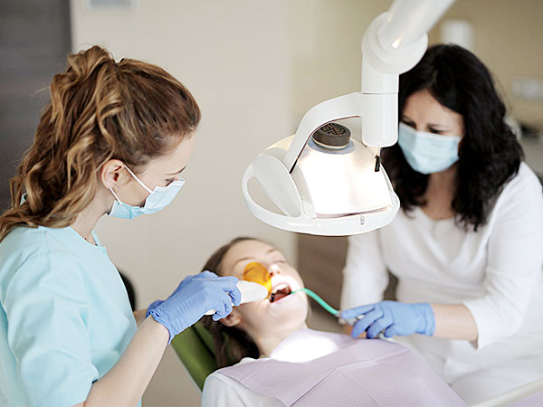 Teeth cleaning, dentist and hygienist with patient